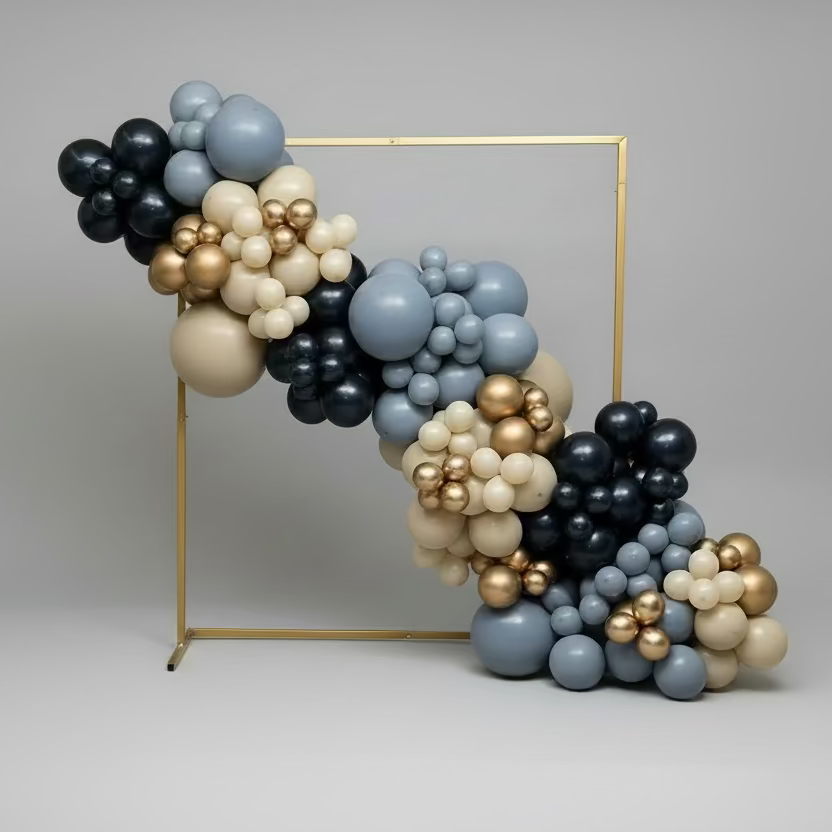 Balloon arch with blue, black, and gold balloons on a gray background