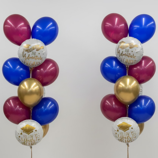 Colorful balloons with graduation-themed messages in a store setting