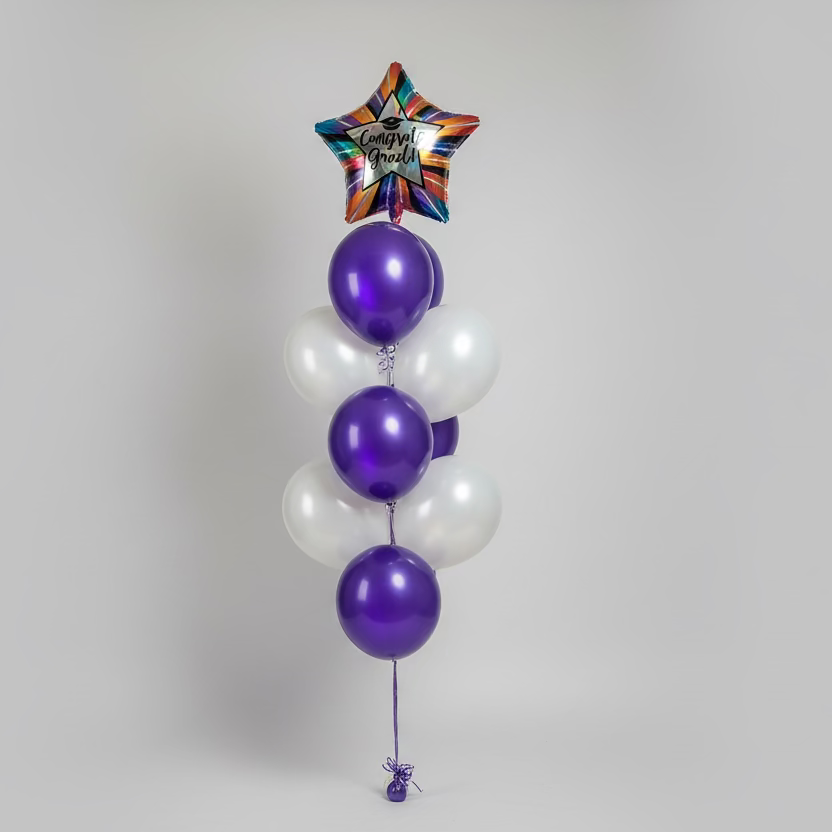 Balloon arrangement with purple and white balloons in a store setting
