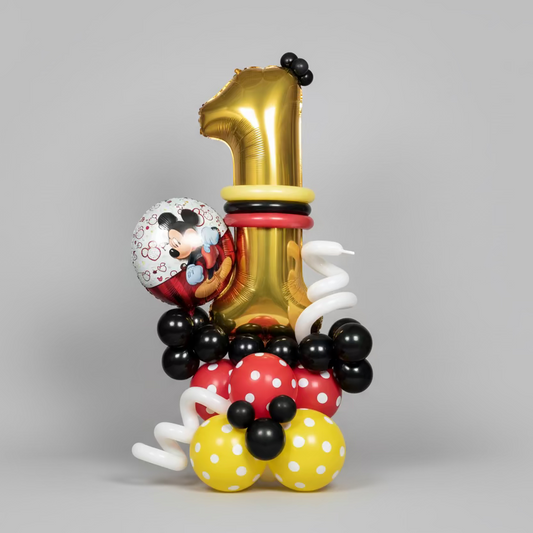 Balloon arrangement with number '1' and Mickey Mouse design on a gray background