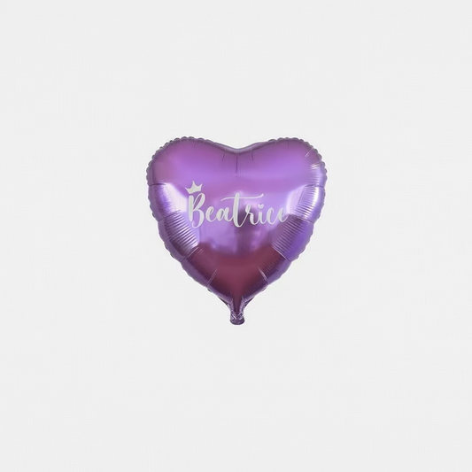 Heart-shaped purple balloon with 'Beatrice' printed on it against a tinsel curtain background.