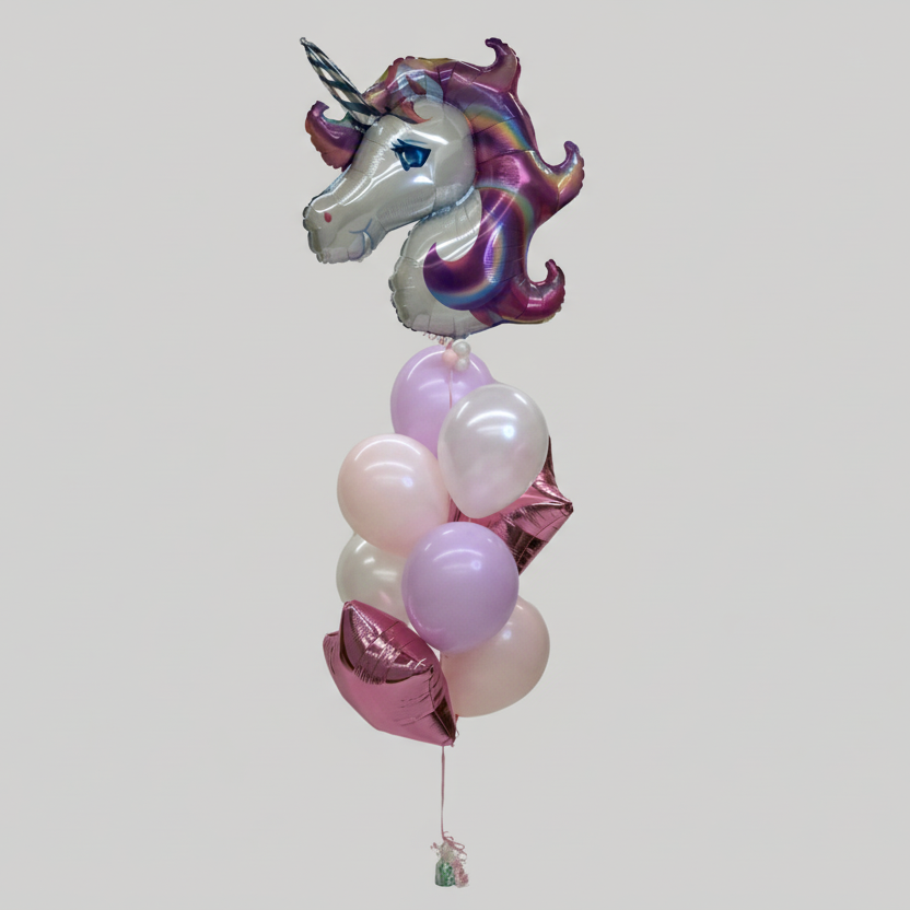 A balloon bundle featuring a large unicorn-shaped foil balloon, with a mane of multicolored confetti and a horn, surrounded by pink and white round balloons.